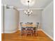Bright dining room with hardwood floors, a chandelier, and neutral-colored walls at 4145 Reflections Pkwy, Sarasota, FL 34233