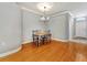 Dining room with hardwood floors and chandelier lighting near the entry at 4145 Reflections Pkwy, Sarasota, FL 34233