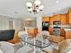 Open dining area with tile floors, a glass table with four chairs, and wooden cabinets at 4145 Reflections Pkwy, Sarasota, FL 34233