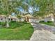 Charming single-story home with a well-manicured lawn and mature trees providing shade and curb appeal at 4145 Reflections Pkwy, Sarasota, FL 34233