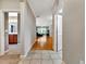Open hallway leading to a bright living area, complemented by tile and wood flooring at 4145 Reflections Pkwy, Sarasota, FL 34233