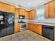 Functional kitchen with stainless steel appliances, tile floors and ample counter space at 4145 Reflections Pkwy, Sarasota, FL 34233