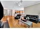 Spacious living area featuring hardwood floors and an open layout to the kitchen at 4145 Reflections Pkwy, Sarasota, FL 34233