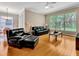 Cozy living room with hardwood floors, comfortable seating, and a large window offering natural light at 4145 Reflections Pkwy, Sarasota, FL 34233