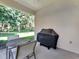 Outdoor patio area with a table, chairs, and a covered grill for outdoor cooking at 4145 Reflections Pkwy, Sarasota, FL 34233