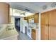 Bright kitchen features wood cabinets, white appliances, and a double sink at 505 30Th W Ave # E304, Bradenton, FL 34205