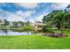Serene community lake with lush landscaping and a clubhouse at 505 30Th W Ave # E304, Bradenton, FL 34205