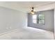 Spacious bedroom with a ceiling fan and window at 505 30Th W Ave # E304, Bradenton, FL 34205