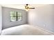 Simple bedroom with window, ceiling fan, and neutral walls at 505 30Th W Ave # E304, Bradenton, FL 34205