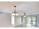 Bright living room features wood-look flooring and access to a balcony at 505 30Th W Ave # E304, Bradenton, FL 34205