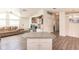 Open kitchen island, gray countertops, and view into living room at 14564 Frizzell Rd, Port Charlotte, FL 33953