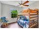 Bedroom with bunk beds, ceiling fan and sitting area at 18050 Wooden Skiff Ct, Nokomis, FL 34275