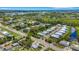 Aerial view highlighting a house's location in a residential area near waterways at 18050 Wooden Skiff Ct, Nokomis, FL 34275