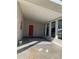 Covered patio with red door and concrete flooring at 3375 8Th St, Sarasota, FL 34237