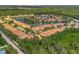 Aerial view of a community with houses, lake, and lush greenery at 4145 Reflections Pkwy, Sarasota, FL 34233