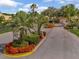 Gated community entrance with lush landscaping and palm trees at 4145 Reflections Pkwy, Sarasota, FL 34233