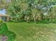 Expansive backyard with lush lawn and mature trees at 4145 Reflections Pkwy, Sarasota, FL 34233