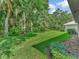 Backyard with lush lawn and mature trees providing shade at 4145 Reflections Pkwy, Sarasota, FL 34233