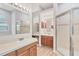 Main bathroom featuring dual sinks and glass-enclosed shower at 6123 55Th E Ter, Bradenton, FL 34203