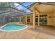 Relaxing screened-in pool area featuring a uniquely shaped pool and lots of outdoor space at 6123 55Th E Ter, Bradenton, FL 34203