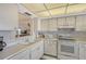 Efficient kitchen featuring white cabinetry and modern appliances at 8911 Midnight Pass Rd # 410, Sarasota, FL 34242