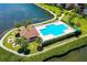 Community pool and sundeck with lush landscaping, offering a relaxing retreat at 8911 Midnight Pass Rd # 410, Sarasota, FL 34242