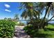 Brick pathway leads to a waterfront gazebo with scenic views at 8911 Midnight Pass Rd # 410, Sarasota, FL 34242