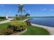 Picturesque waterfront view with lush landscaping and a gazebo at 8911 Midnight Pass Rd # 410, Sarasota, FL 34242