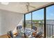 Spacious balcony with glass-top table and chairs, overlooking the water at 8911 Midnight Pass Rd # 410, Sarasota, FL 34242