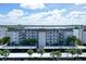 Condo building exterior showcasing covered parking and water views at 8911 Midnight Pass Rd # 410, Sarasota, FL 34242