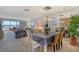 Elegant dining area with chandelier and view into living room at 8911 Midnight Pass Rd # 410, Sarasota, FL 34242