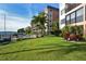 Resort-style pool area with lush landscaping and building view at 8911 Midnight Pass Rd # 410, Sarasota, FL 34242