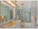 Retro bathroom with a bathtub, shower, and bamboo-print wallpaper at 8911 Midnight Pass Rd # 410, Sarasota, FL 34242