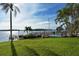 Community pool with waterfront view and lush landscaping at 8911 Midnight Pass Rd # 410, Sarasota, FL 34242