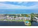 Aerial view showcasing waterfront property and community pool at 8911 Midnight Pass Rd # 410, Sarasota, FL 34242