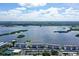 Aerial view of waterfront condo building with tennis courts at 8911 Midnight Pass Rd # 410, Sarasota, FL 34242