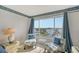 Bedroom with water views and blue patterned armchairs at 8911 Midnight Pass Rd # 410, Sarasota, FL 34242