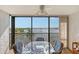 Balcony with glass-top table and chairs offering water views at 8911 Midnight Pass Rd # 410, Sarasota, FL 34242