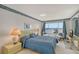 Main bedroom with water views and light blue bedding at 8911 Midnight Pass Rd # 410, Sarasota, FL 34242