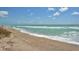 Scenic view of a tranquil beach with soft sand and gentle waves at 8911 Midnight Pass Rd # 410, Sarasota, FL 34242