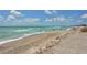 Expansive beach with ocean waves and people enjoying the day at 8911 Midnight Pass Rd # 410, Sarasota, FL 34242