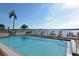 Refreshing community pool with waterfront views and lounge chairs at 8911 Midnight Pass Rd # 410, Sarasota, FL 34242