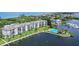 Aerial view of condo complex with pool and boat docks at 8911 Midnight Pass Rd # 410, Sarasota, FL 34242