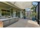 Large screened patio with seating area and views of the backyard at 350 River Enclave Ct, Bradenton, FL 34212