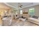Living room with sectional sofa, large rug and adjacent dining area at 350 River Enclave Ct, Bradenton, FL 34212