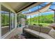 Relaxing screened patio with wicker furniture and lush landscaping at 350 River Enclave Ct, Bradenton, FL 34212
