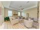 Spacious living room with light beige sectional sofa and a ceiling fan at 350 River Enclave Ct, Bradenton, FL 34212