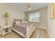Bright bedroom with a queen-size bed, wooden nightstands, and ceiling fan at 350 River Enclave Ct, Bradenton, FL 34212