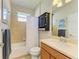 Clean bathroom with a bathtub, toilet, vanity, and linen cabinet at 350 River Enclave Ct, Bradenton, FL 34212