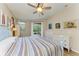 Relaxing bedroom with light blue bed frame, striped bedding, and access to a patio at 350 River Enclave Ct, Bradenton, FL 34212
